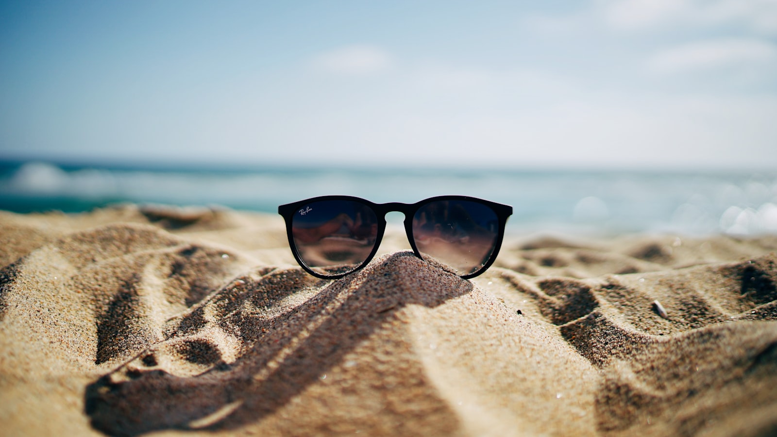 Woman in sunglasses under bright sun — polarized vs UV protection explained