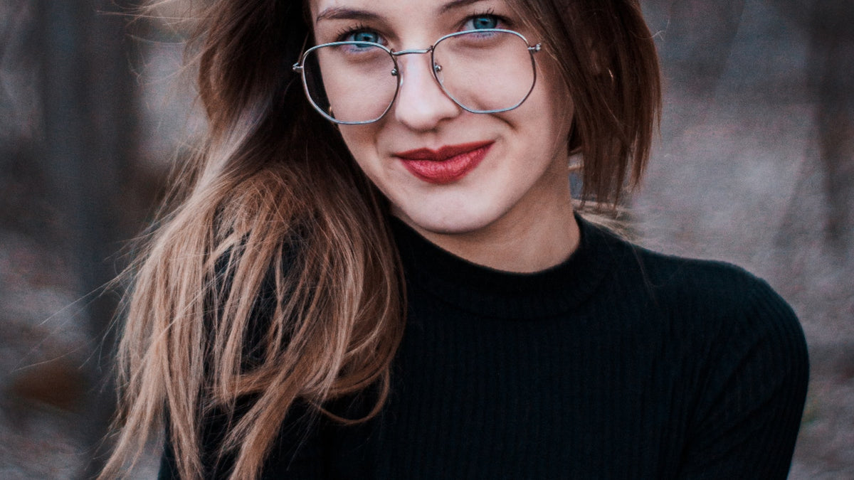 Woman wearing eyeglasses outdoors in bright daylight