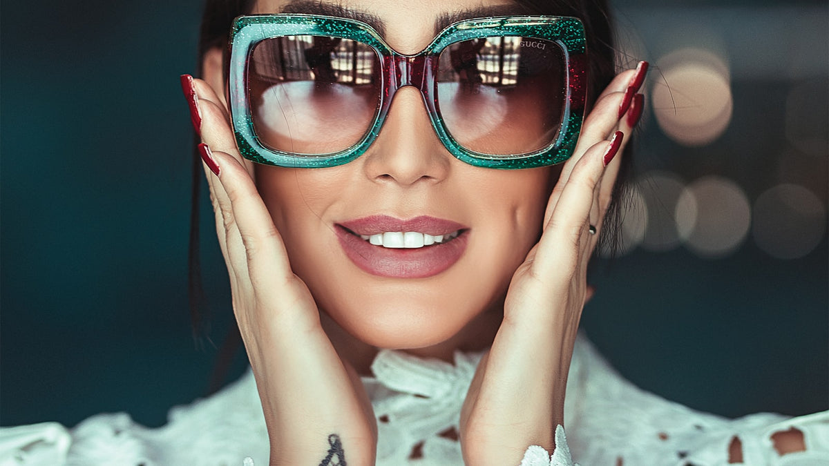 Woman wearing bold sunglasses in bright daylight