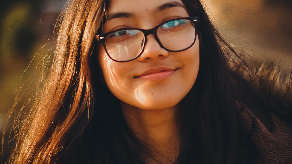 Person adjusting new glasses