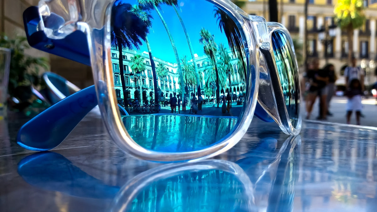 Gray and blue mirrored sunglasses on a table