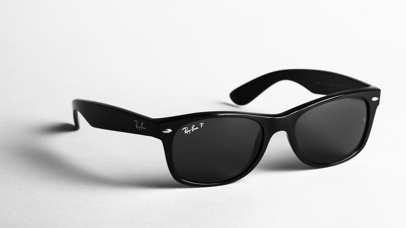 Orange-framed sunglasses in bright sunlight — what UV400 means on sunglasses