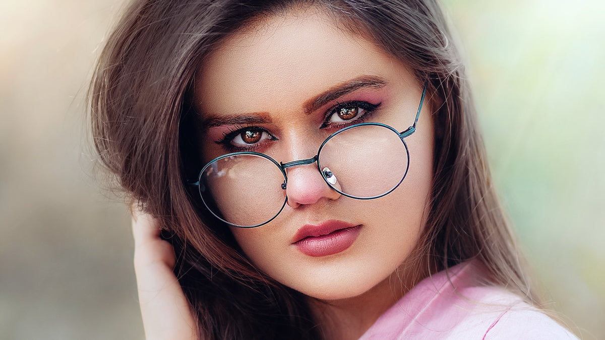 Close-up of a person wearing black-framed glasses