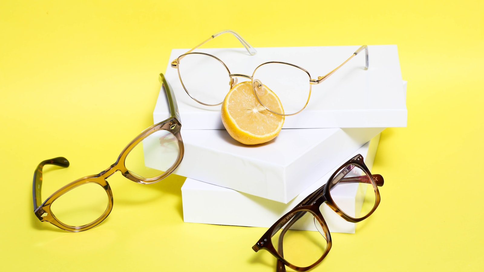 Several pairs of eyeglasses in different shapes arranged together — face shape and frame shape matrix