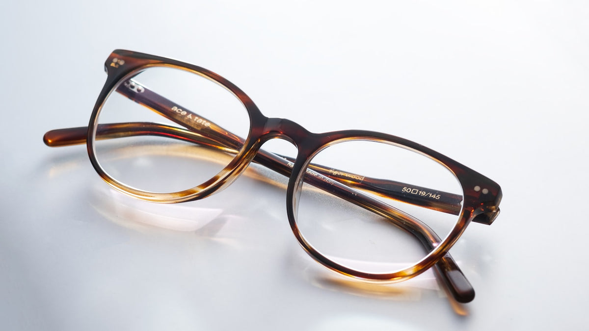Black and brown framed eyeglasses on a surface