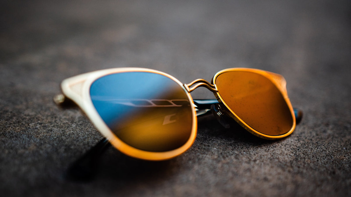 Mirrored sunglasses reflecting a bright sky
