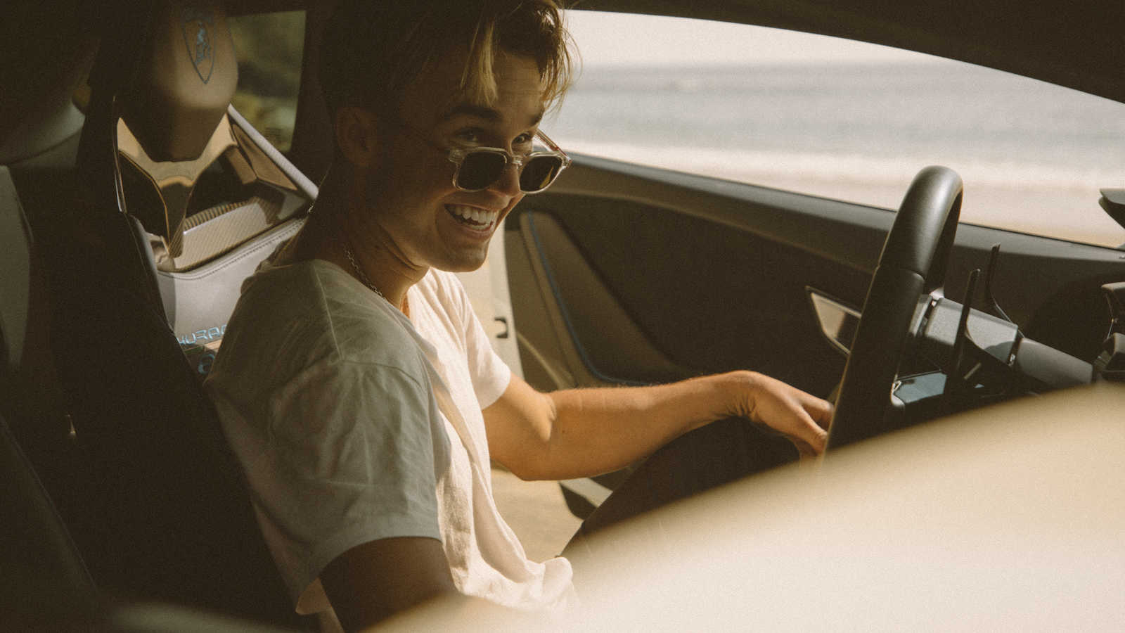 Driver wearing polarized sunglasses on a sunny road — are polarized sunglasses worth it for driving