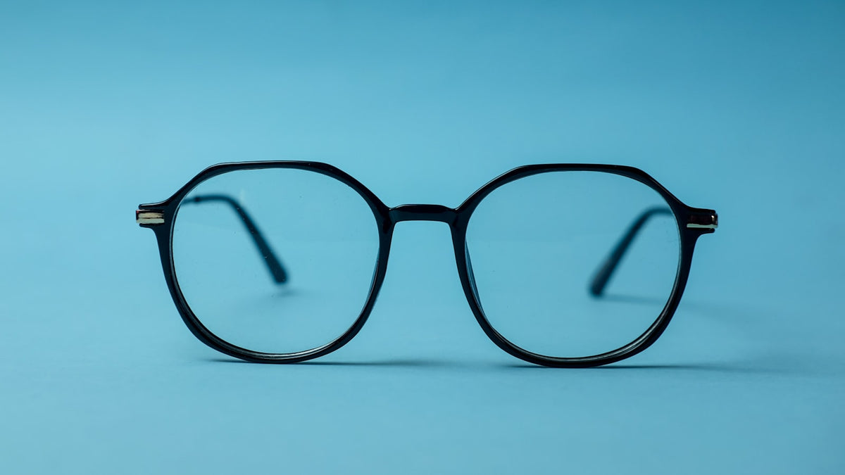 Black-framed eyeglasses on a white surface