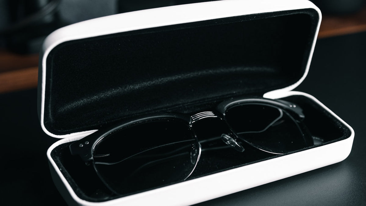 Eyeglasses resting in an open case on a table